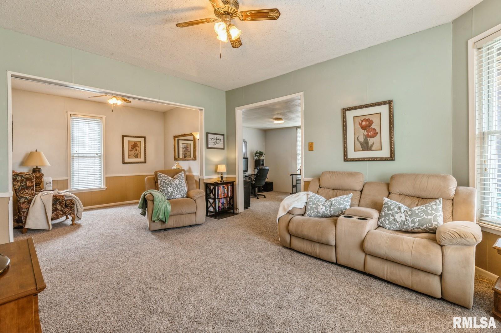 1301 Caroline Avenue Clinton, IA 52732 - Photo 10 of 19 a living room with furniture and a lamp