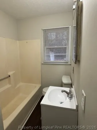 a bathroom with a sink a toilet and a bathtub