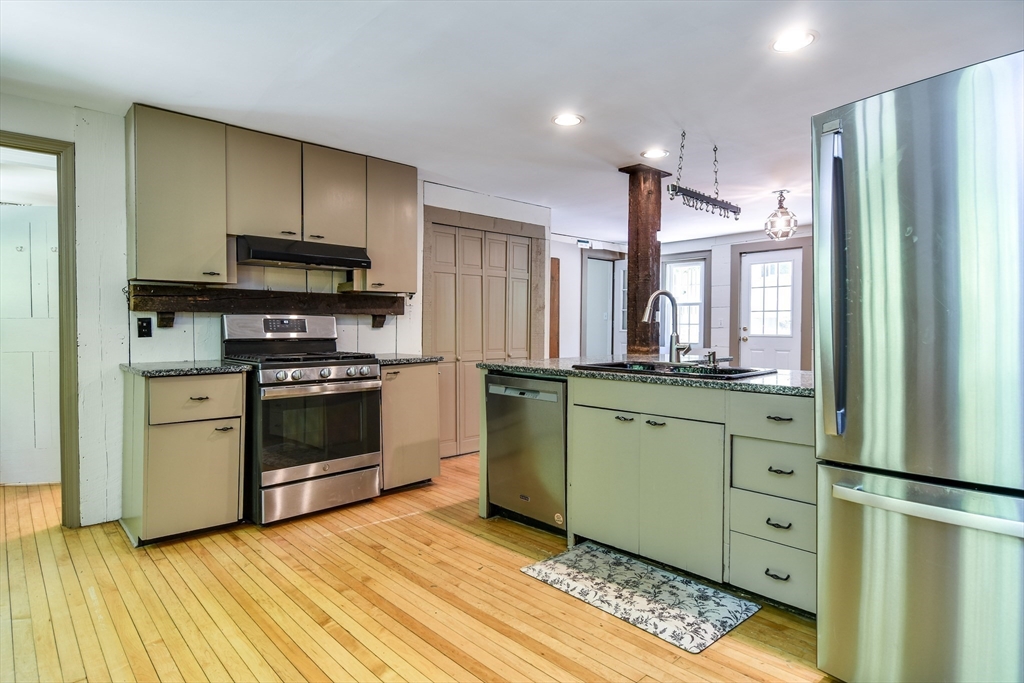 33 Grove Street Framingham, MA 01701 - Photo 6 of 33 a kitchen with a refrigerator and a stove top oven