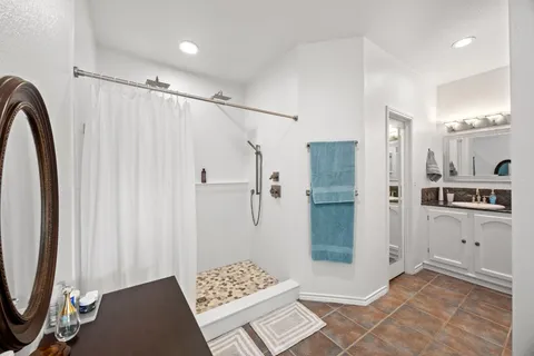 a bathroom with a shower and a sink