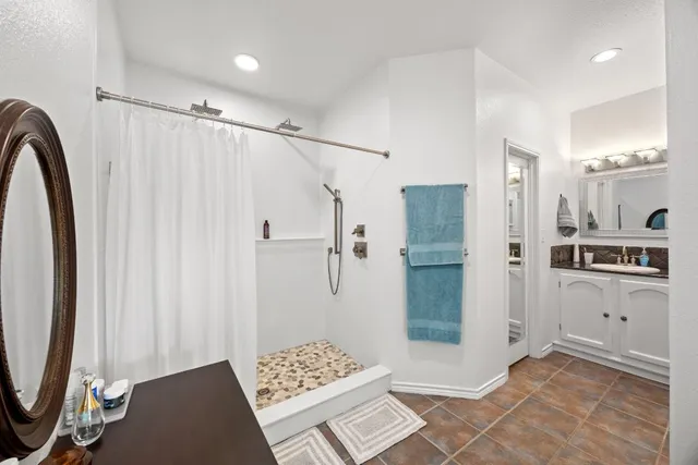 a bathroom with a shower and a sink