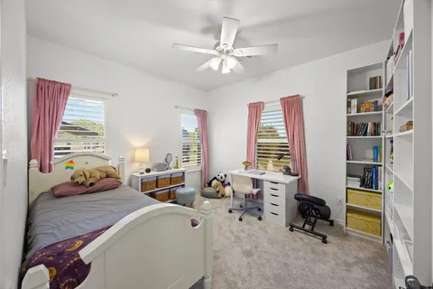 a bedroom with furniture and a large window