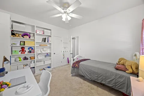 a bedroom with a bed furniture and a chandelier