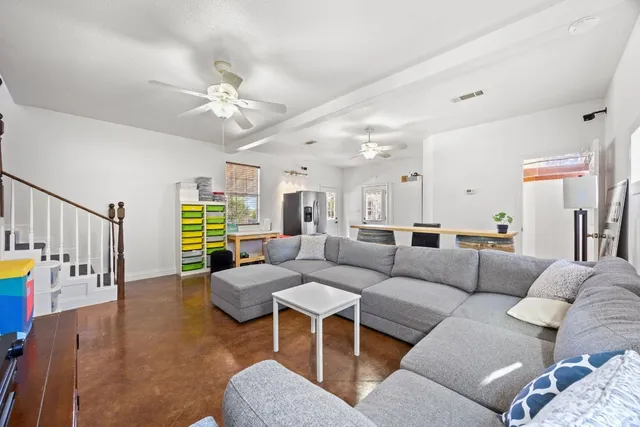 a living room with furniture and a chandelier