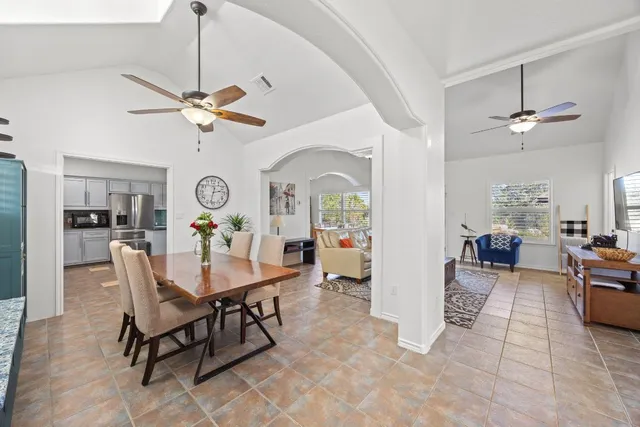 a living room with furniture fireplace and a window