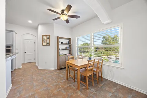 a dining room with furniture and window