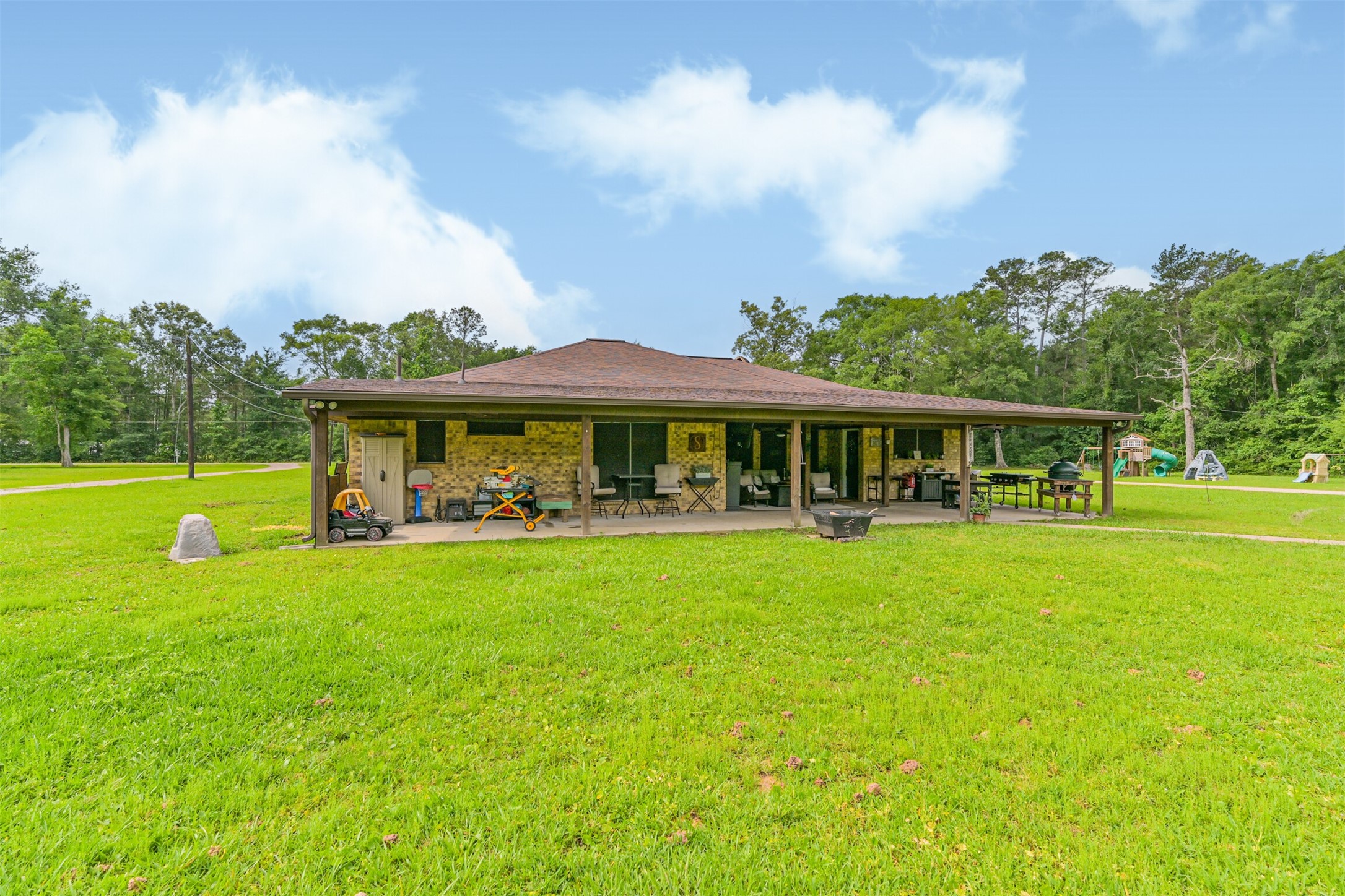 26925 Brentwood Road Splendora, TX 77372 - Photo 1 of 30 a front view of a house with garden