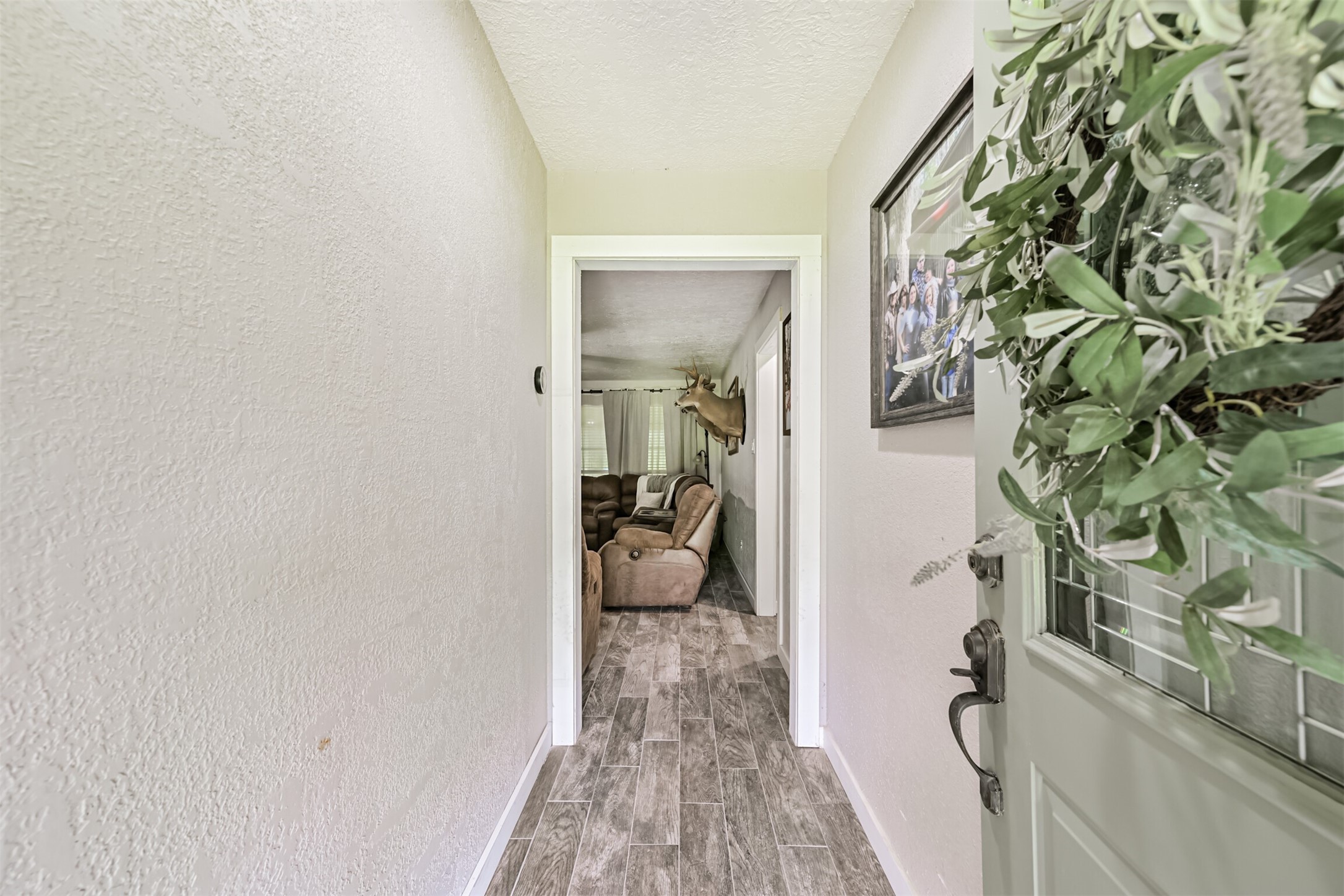 26925 Brentwood Road Splendora, TX 77372 - Photo 12 of 30 a view of a hallway with furniture and a window