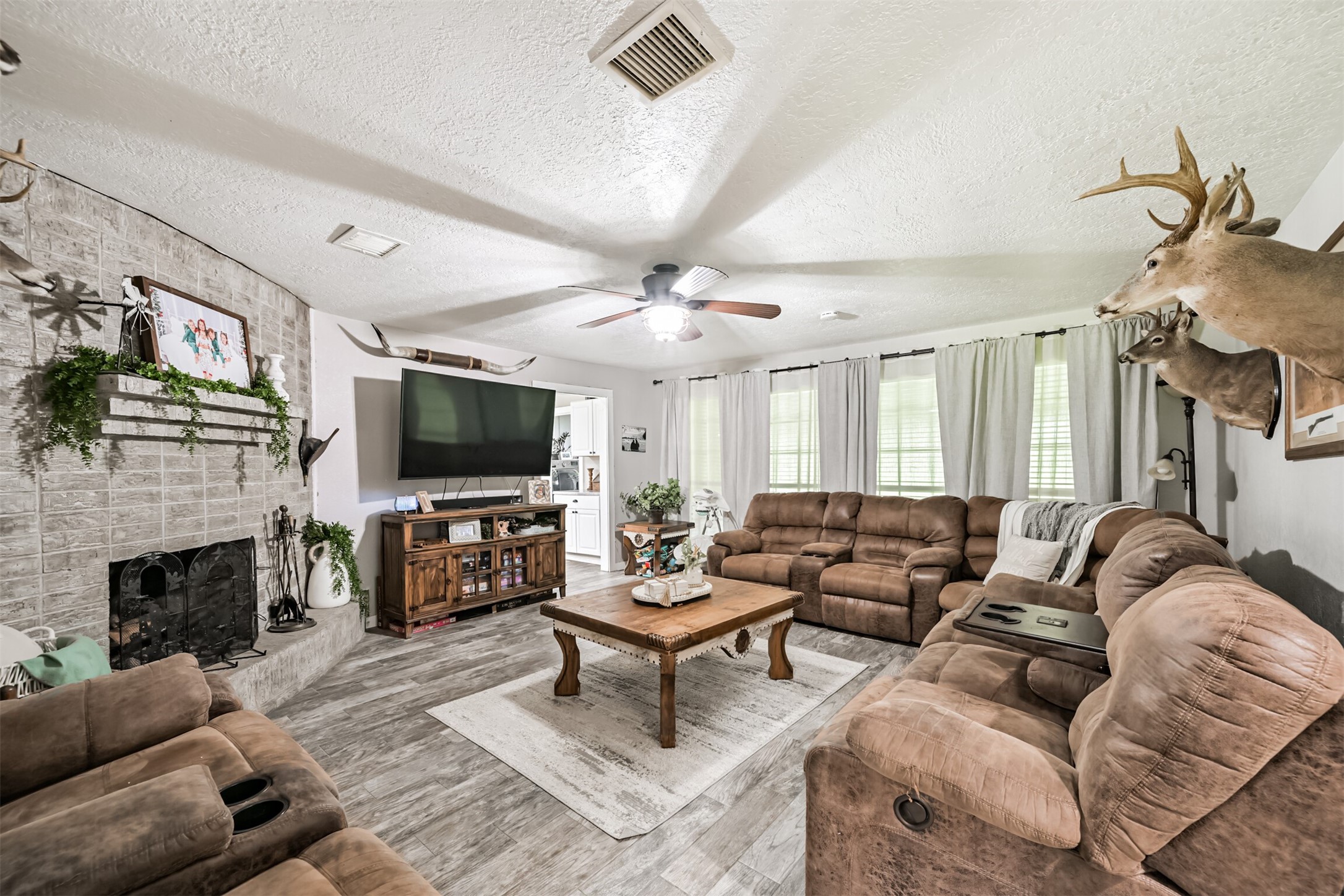 26925 Brentwood Road Splendora, TX 77372 - Photo 13 of 30 a living room with fireplace furniture and a flat screen tv