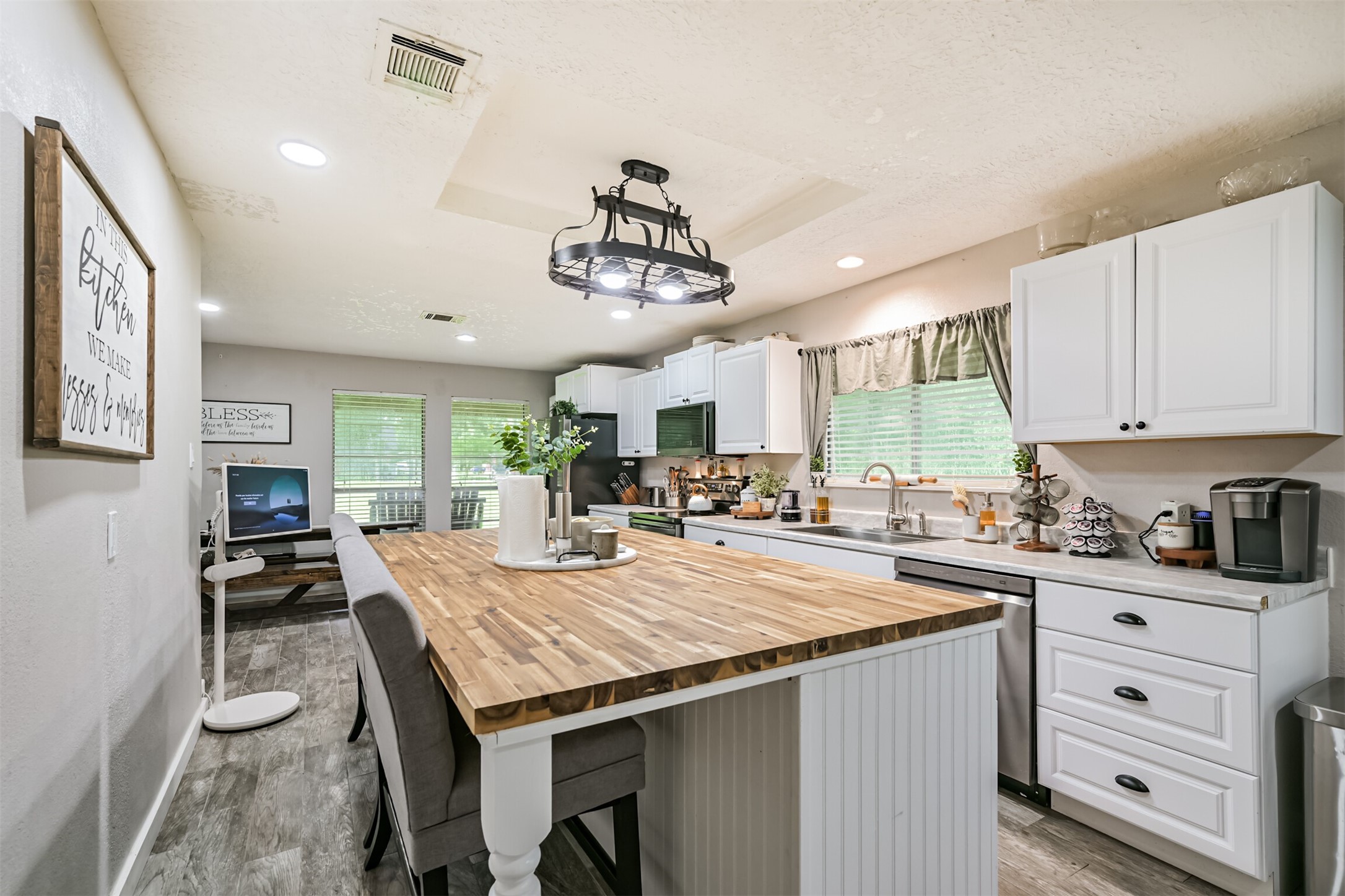 26925 Brentwood Road Splendora, TX 77372 - Photo 15 of 30 a kitchen with granite countertop a sink stove and cabinets