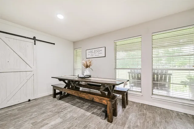 a living room with furniture a rug and a large window