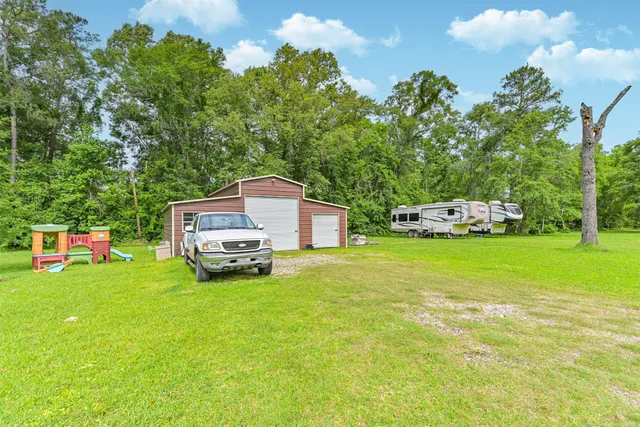 a car parked in front of a house with a small yard
