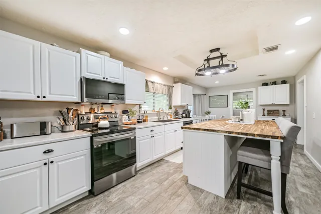 a kitchen with cabinets a sink and appliances in it
