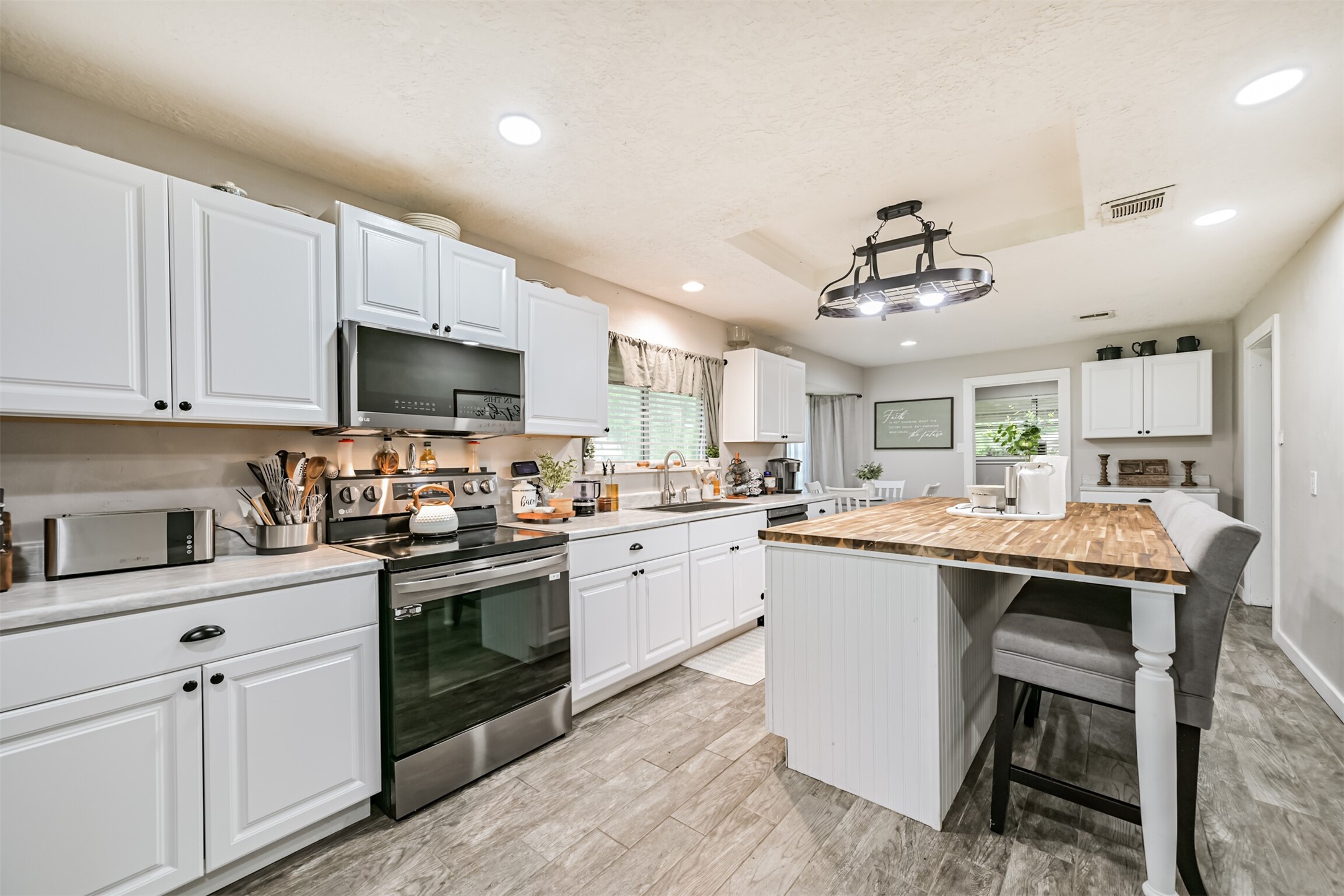 26925 Brentwood Road Splendora, TX 77372 - Photo 22 of 30 a kitchen with cabinets a sink and appliances in it