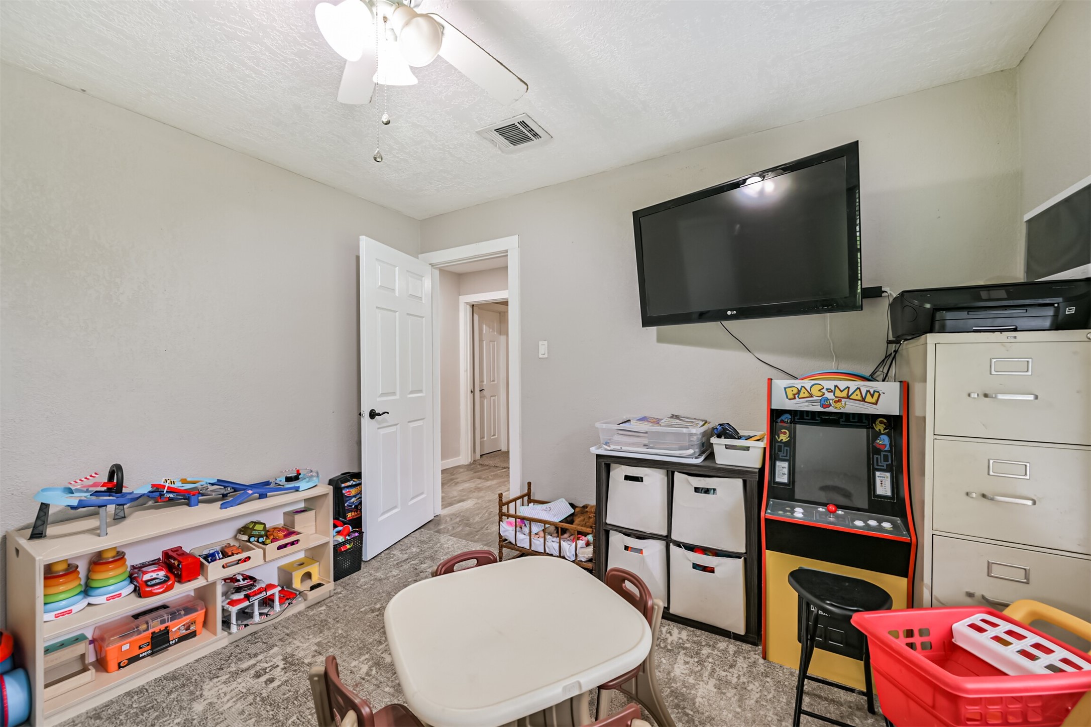 26925 Brentwood Road Splendora, TX 77372 - Photo 27 of 30 a living room with furniture and a flat screen tv