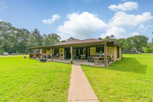 a view of a house with a swimming pool and a yard