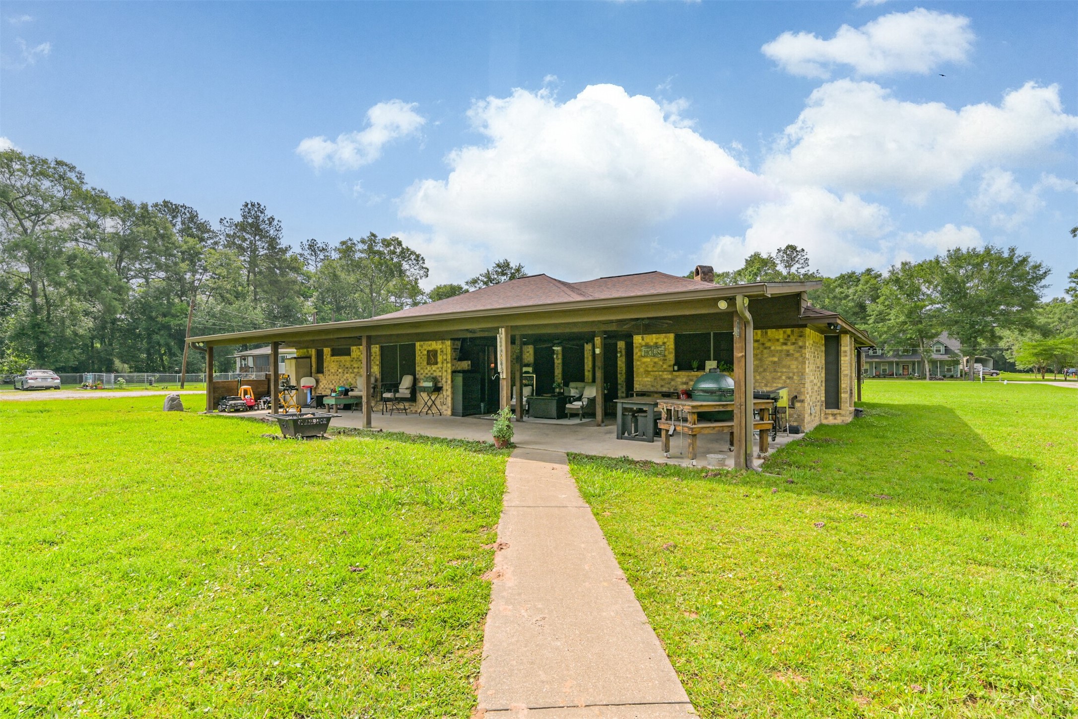 26925 Brentwood Road Splendora, TX 77372 - Photo 30 of 30 a view of a house with a swimming pool and a yard