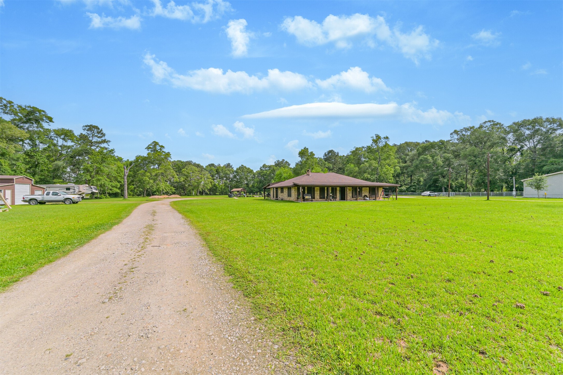 26925 Brentwood Road Splendora, TX 77372 - Photo 3 of 30 a view of a house with a yard and potted plants