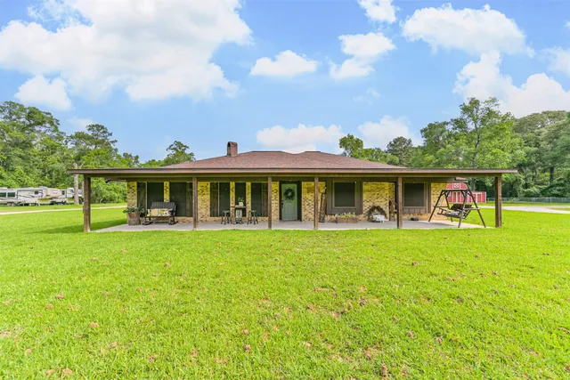 a front view of a house with table and chairs