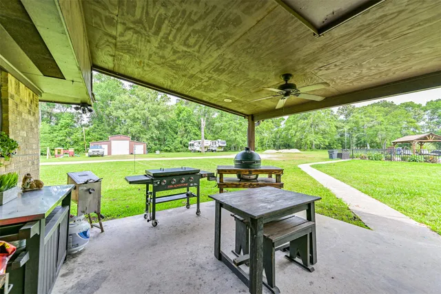 a backyard of a house with yard and outdoor seating