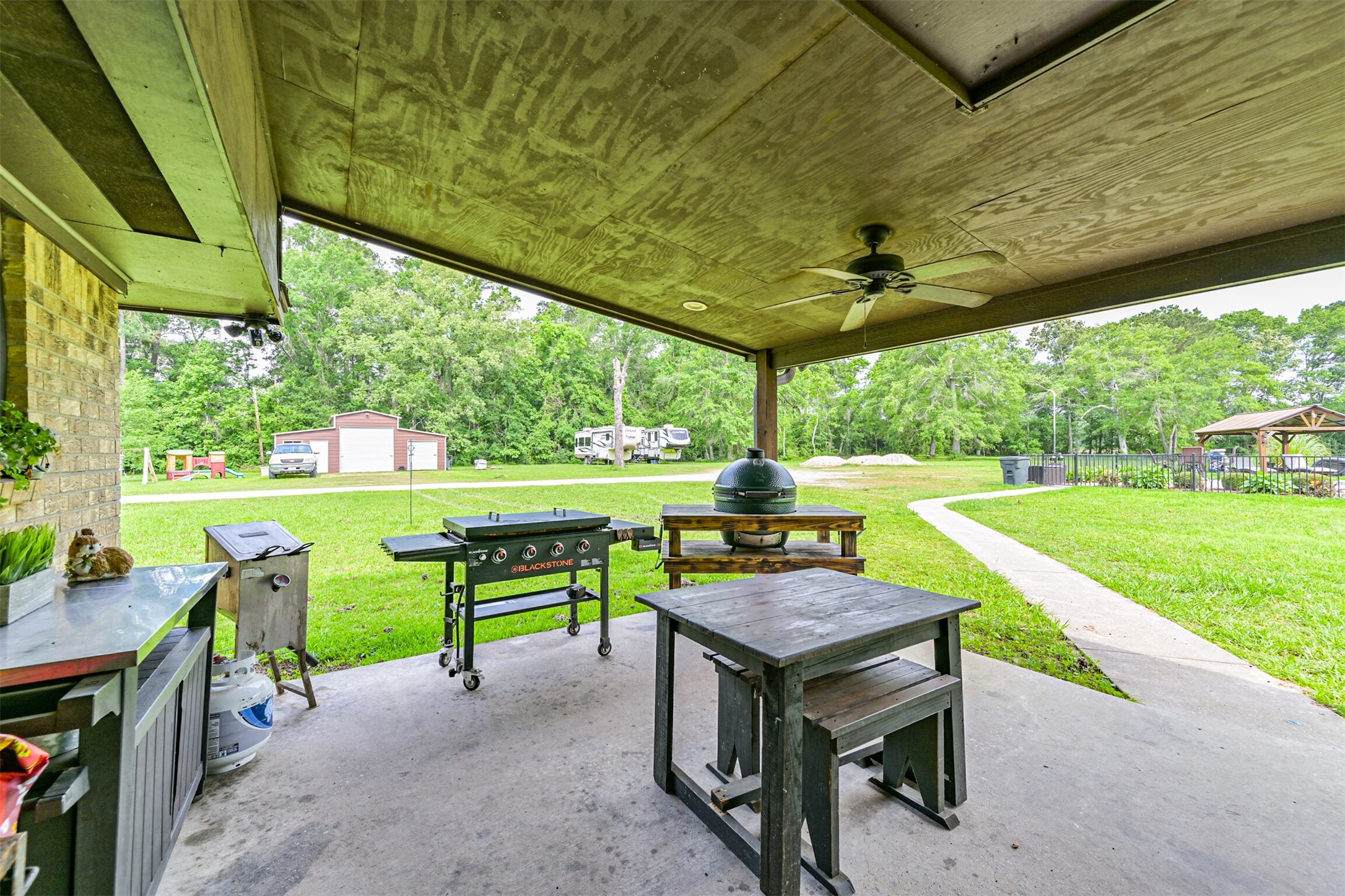 26925 Brentwood Road Splendora, TX 77372 - Photo 8 of 30 a backyard of a house with yard and outdoor seating
