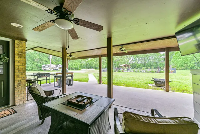 a living room with large window and a table