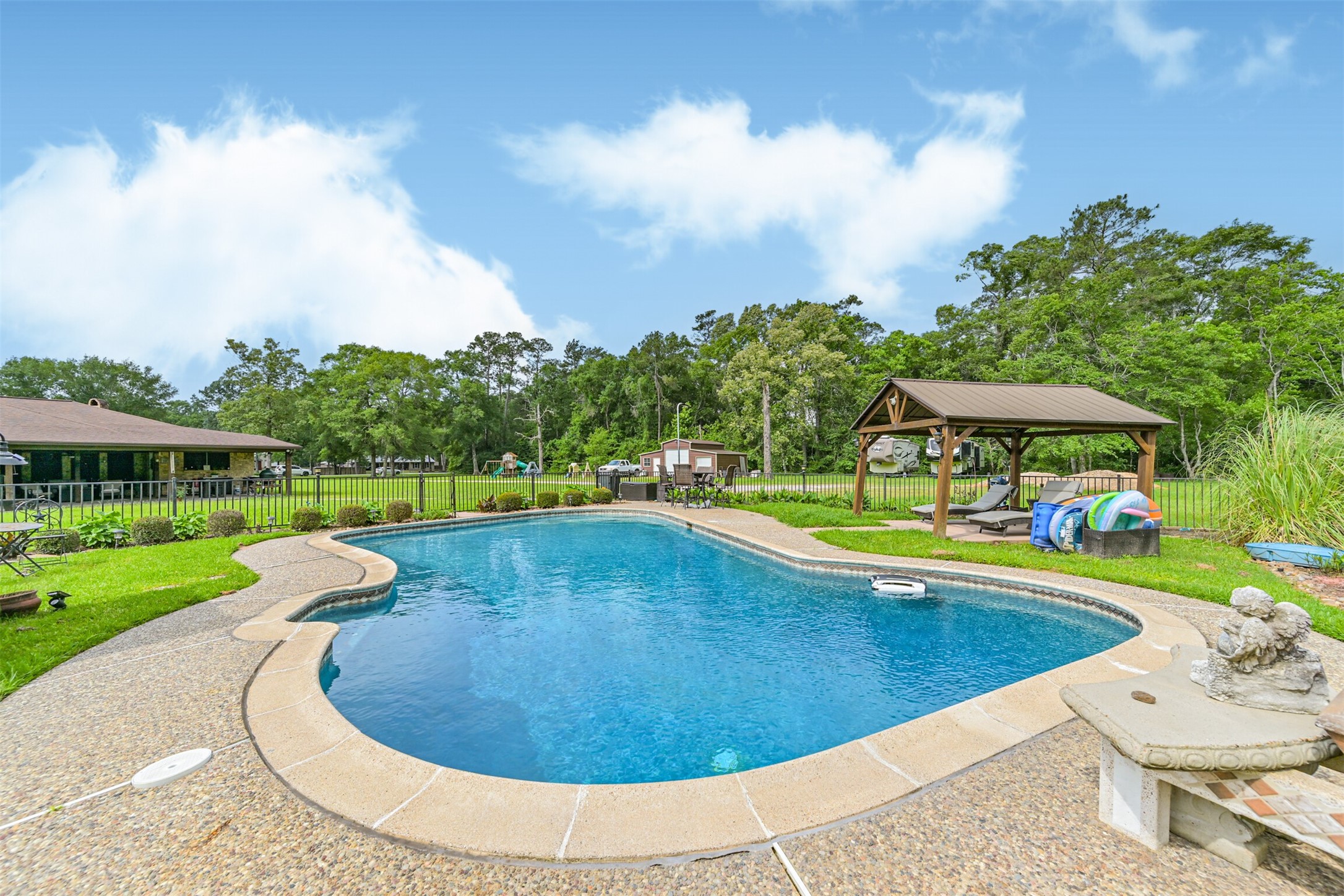 26925 Brentwood Road Splendora, TX 77372 - Photo 10 of 30 a view of a swimming pool with lounge chair