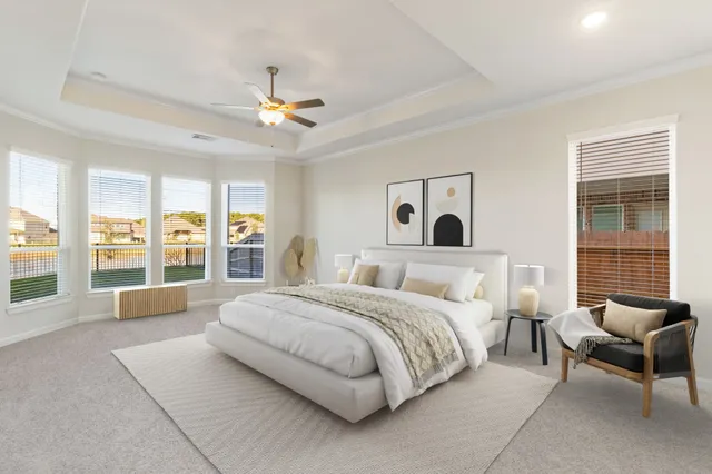 a spacious bedroom with a large bed and a large window