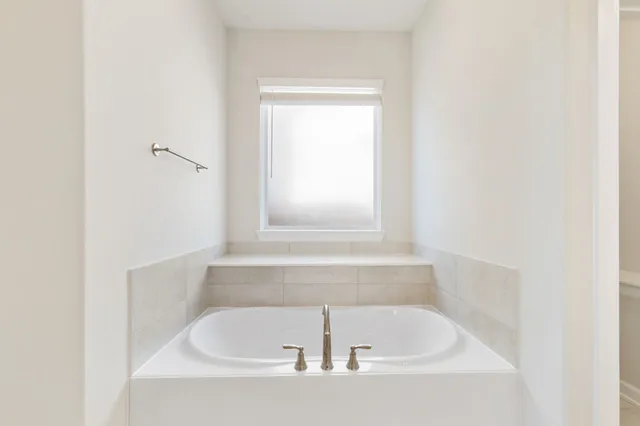 a white bath tub sitting in a bathroom