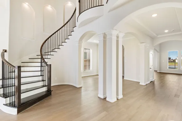 a view of entryway with wooden floor and stairs