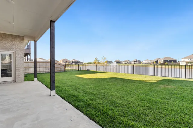 a view of a green field with sitting area