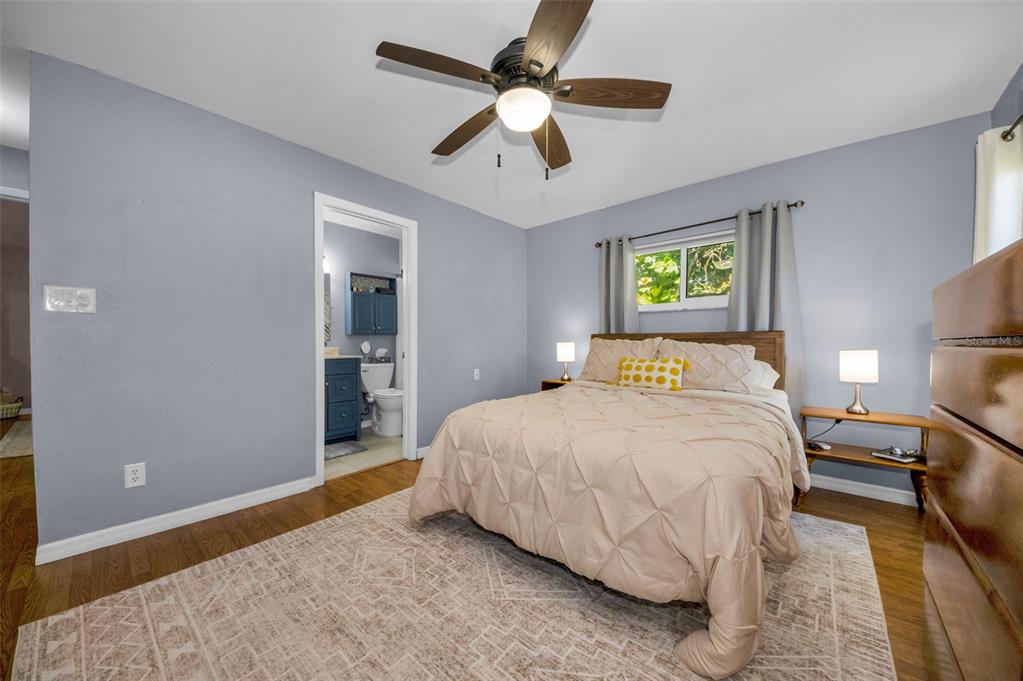 8037 Powder Horn Circle Largo, FL 33773 - Photo 11 of 27 a bedroom with a bed and a ceiling fan