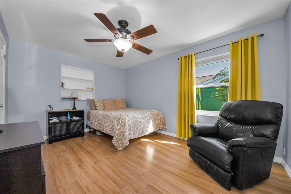 8037 Powder Horn Circle Largo, FL 33773 - Photo 14 of 27 a bedroom with a bed and wooden floor