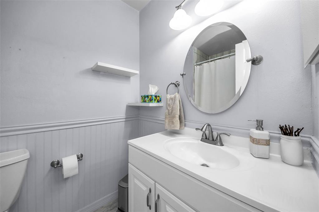 8037 Powder Horn Circle Largo, FL 33773 - Photo 16 of 27 a bathroom with a sink and a mirror