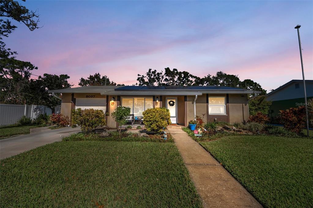 8037 Powder Horn Circle Largo, FL 33773 - Photo 18 of 27 a front view of a house with garden