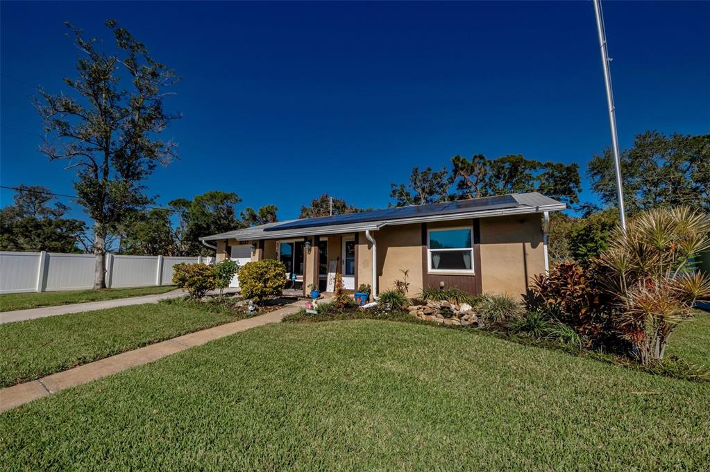 8037 Powder Horn Circle Largo, FL 33773 - Photo 25 of 27 a front view of a house with garden