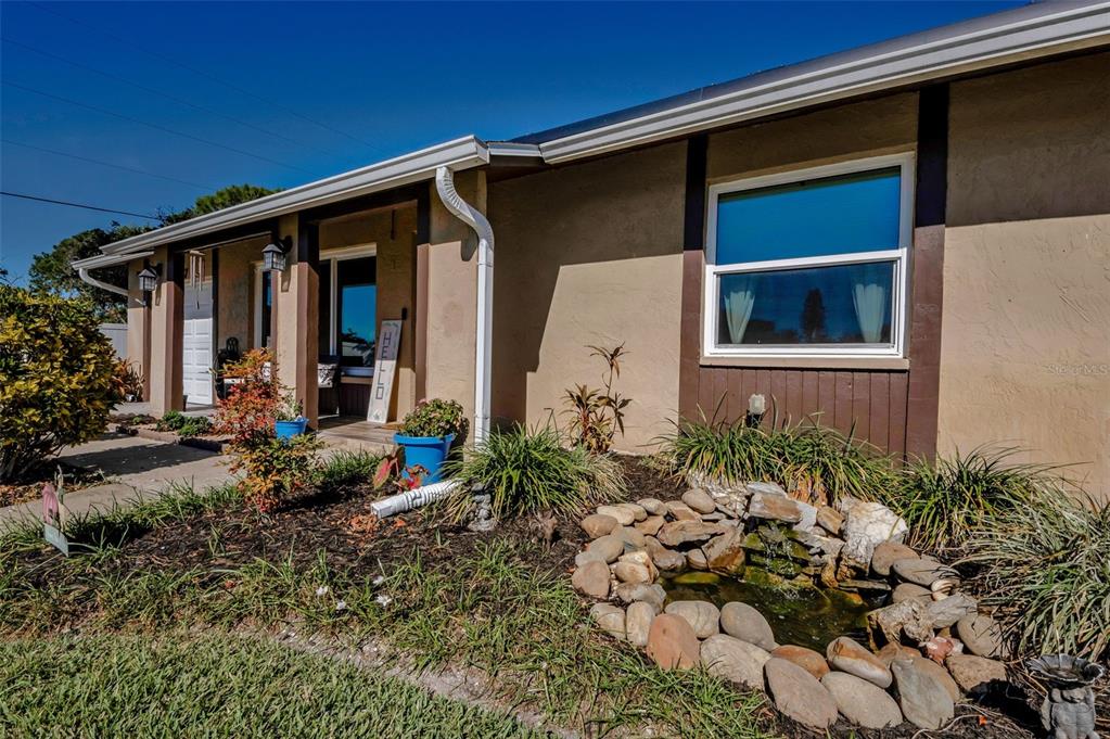 8037 Powder Horn Circle Largo, FL 33773 - Photo 26 of 27 a backyard of a house with flower plants