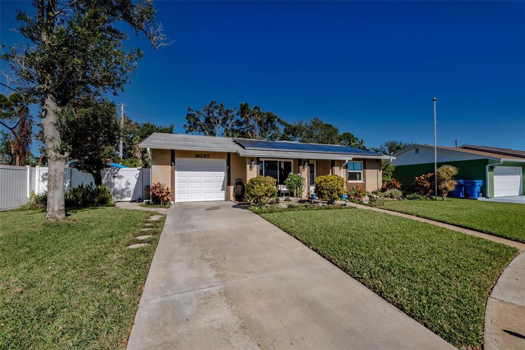 8037 Powder Horn Circle Largo, FL 33773 - Photo 27 of 27 a front view of a house with a garden and yard