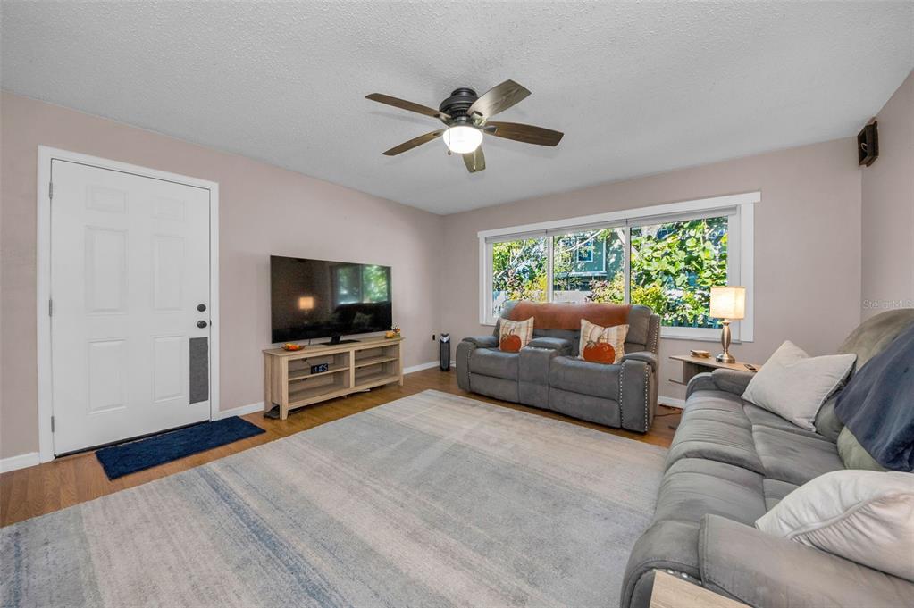 8037 Powder Horn Circle Largo, FL 33773 - Photo 3 of 27 a living room with furniture and a flat screen tv