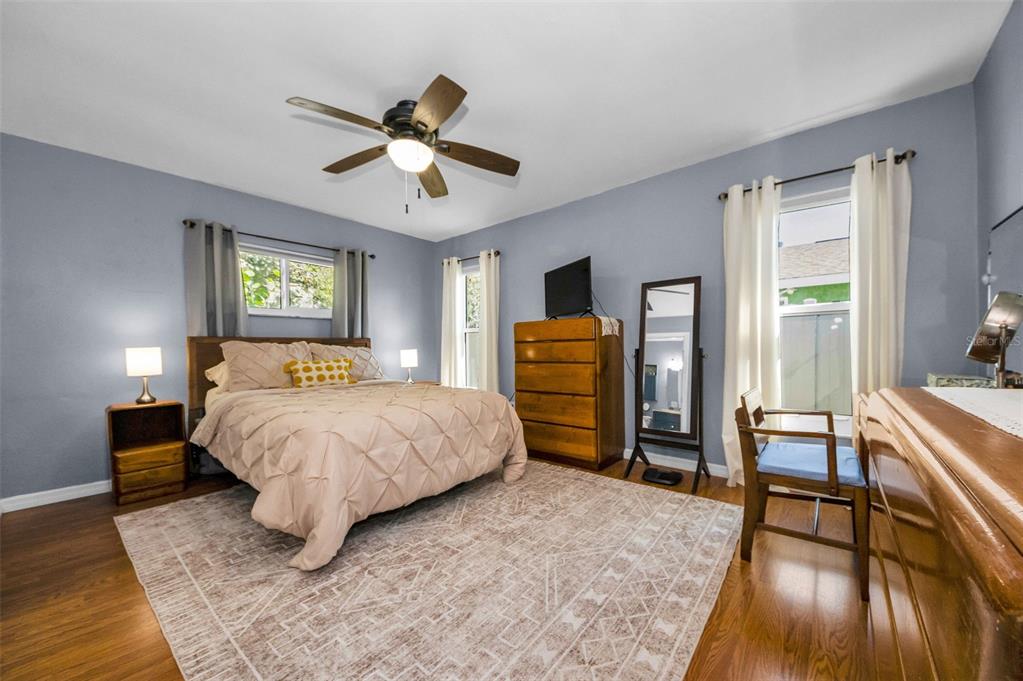 8037 Powder Horn Circle Largo, FL 33773 - Photo 10 of 27 a bedroom with a bed and wooden floor
