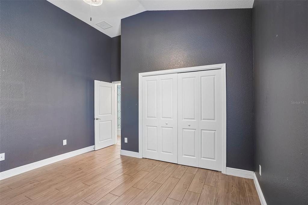 10339 Addison Shore Way Oxford, FL 34484 - Photo 49 of 54 a view of an empty room with wooden floor