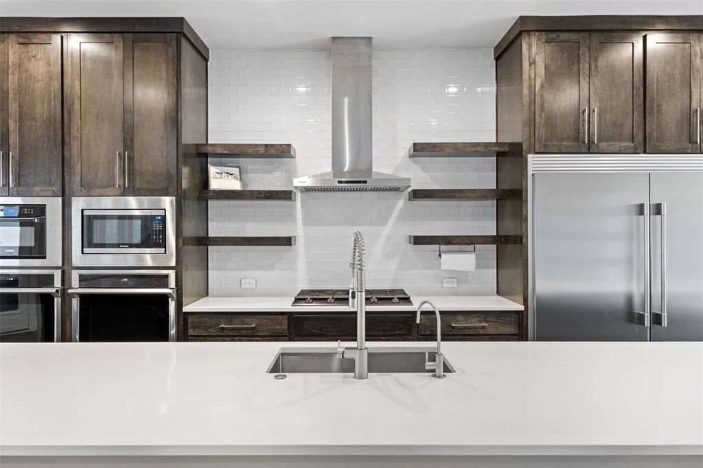 1730 Lone Elm Road Waxahachie, TX 75167 - Photo 17 of 40 a kitchen with stainless steel appliances wooden floor and window