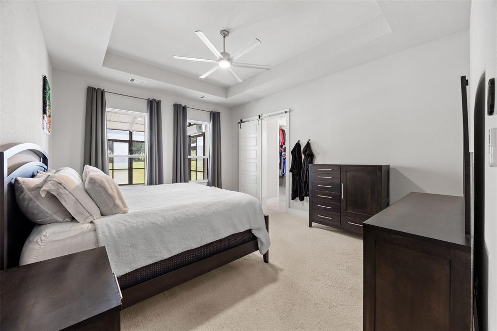 1730 Lone Elm Road Waxahachie, TX 75167 - Photo 21 of 40 a bed room with a bed and a large mirror