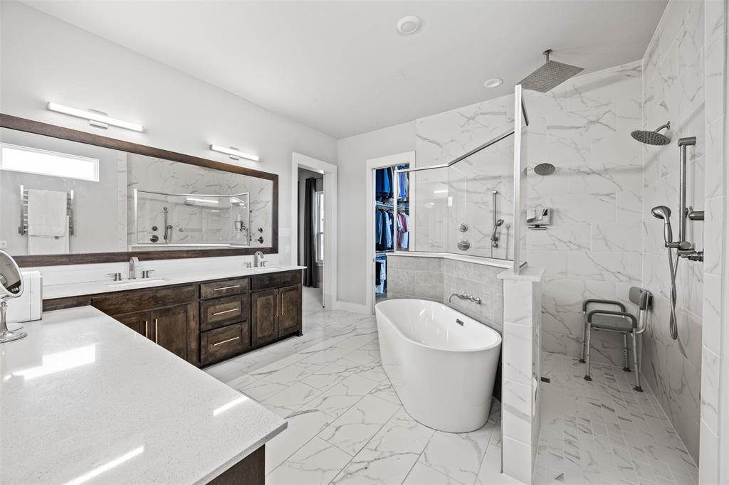 1730 Lone Elm Road Waxahachie, TX 75167 - Photo 24 of 40 a large bathroom with a granite countertop toilet a sink a mirror a bathtub and shower