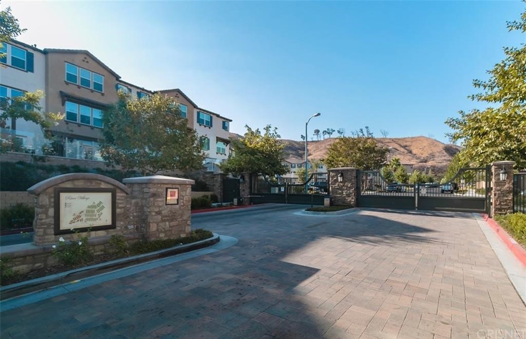 22166 Barrington Way Saugus, CA 91350 - Photo 16 of 19 a front view of a house with a yard and tree s