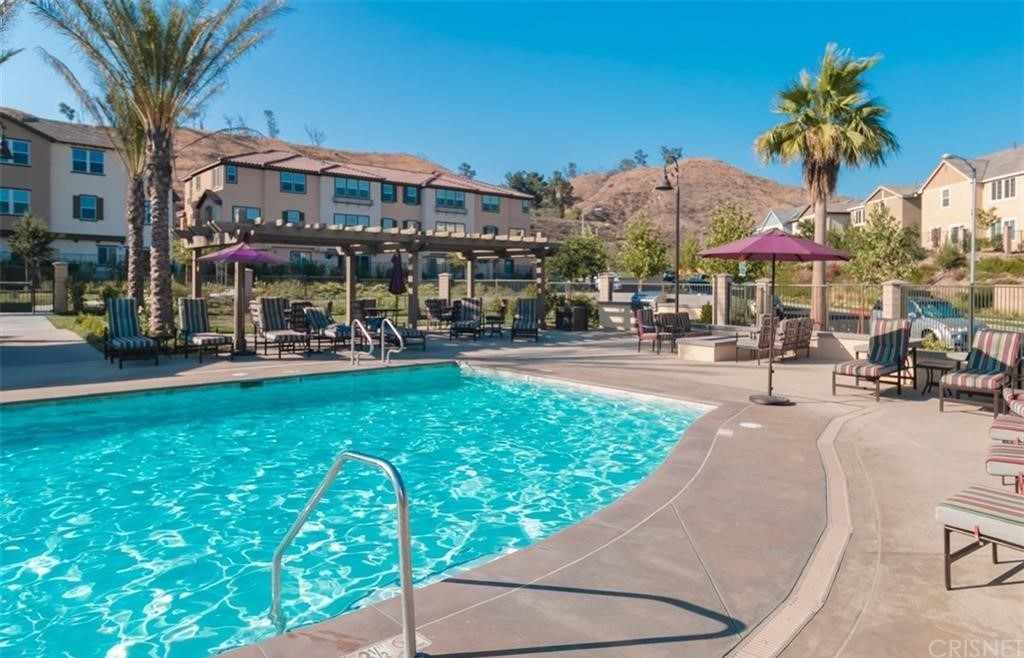 22166 Barrington Way Saugus, CA 91350 - Photo 18 of 19 a view of a patio with a table and chairs under an umbrella