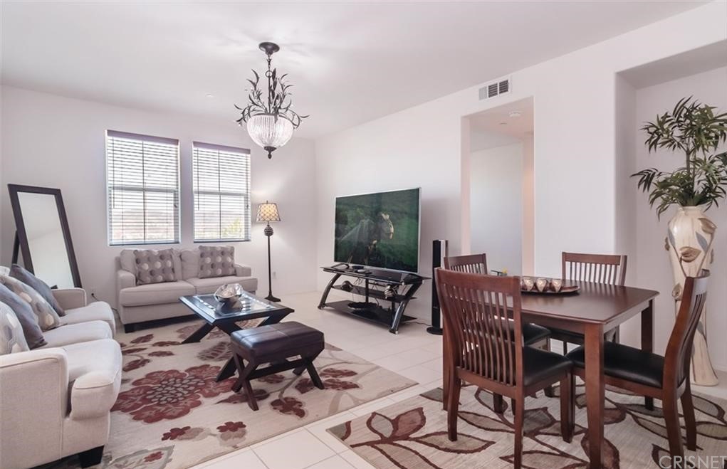 22166 Barrington Way Saugus, CA 91350 - Photo 6 of 19 a living room with furniture a chandelier and a flat screen tv