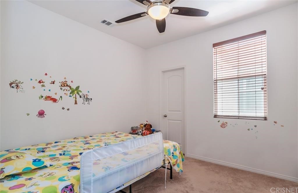22166 Barrington Way Saugus, CA 91350 - Photo 10 of 19 a bedroom with a bed and a window
