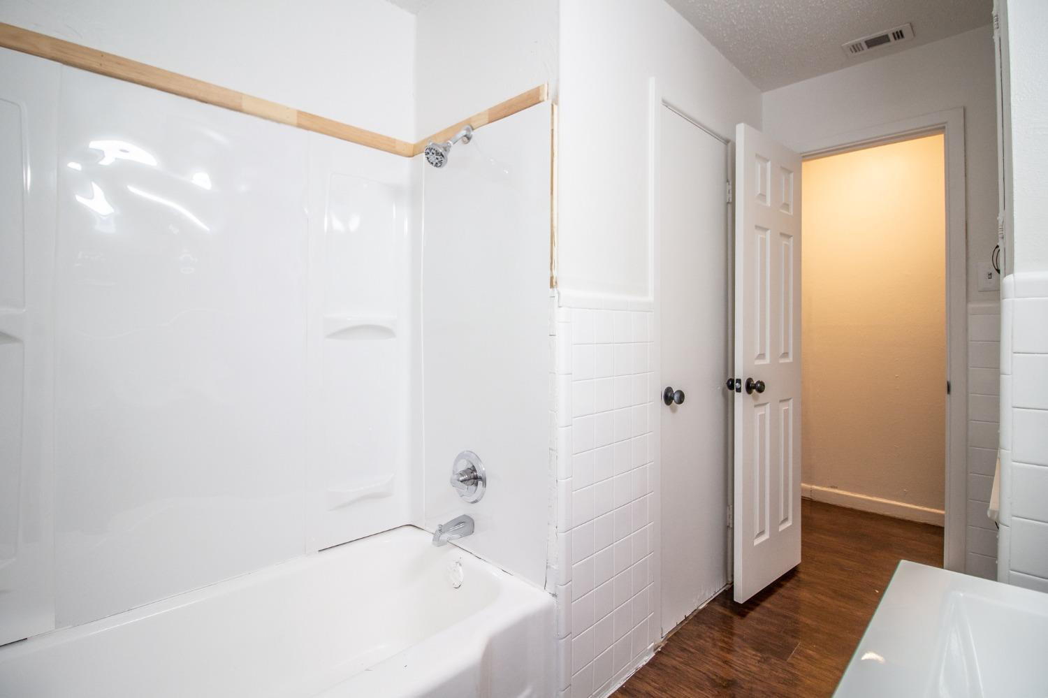5105 39th Street Lubbock, TX 79414 - Photo 16 of 18 a bathroom with a bathtub and a sink