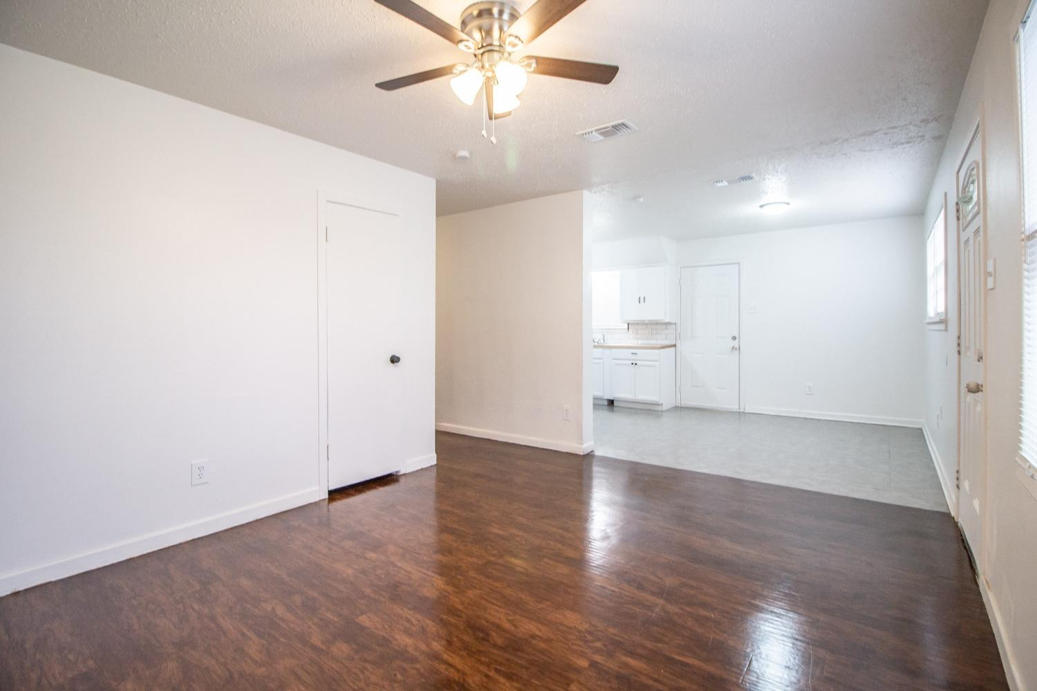 5105 39th Street Lubbock, TX 79414 - Photo 5 of 18 an empty room with wooden floor and windows